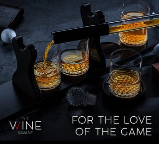 A whiskey decanter set featuring a golf club-shaped decanter and four whiskey glasses arranged on a mahogany wood base.