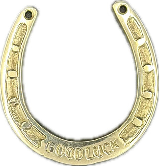 Gold horseshoe charm with 'Good Luck' engraving on a white background