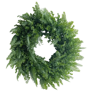 Greenery Wreath 20" 
A lush green artificial wreath made of faux ferns and boxwood leaves, displayed against a plain white wall.