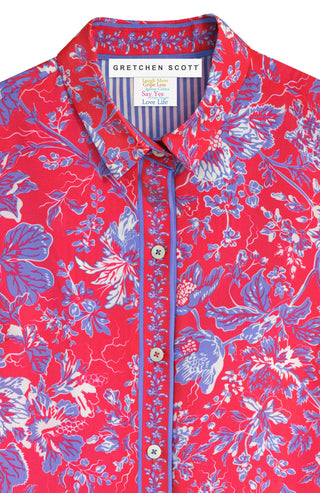 Close-up of a red Gretchen Scott boyfriend shirt with a floral pattern and shell buttons.