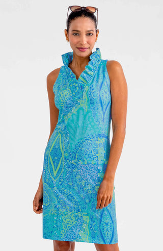 A woman wearing a sleeveless, ruffle neck, turquoise print dress with a stand-up collar.