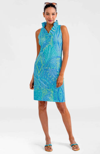 A woman wearing a sleeveless, ruffle neck, turquoise print dress with a stand-up collar.
