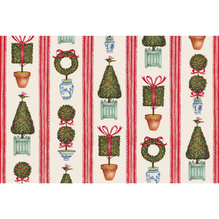 Patterned paper placemat with Christmas-themed topiary trees, wreaths, and ribbons on a striped background. Hester & Cook Holiday Topiary Placemats