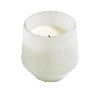 A white, tapered glass candle with a natural wax 