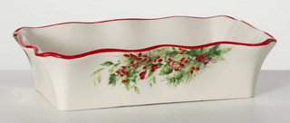 Decorative ceramic dish with red rim and floral design on a white background