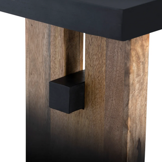 Close-up of a wooden table with a black square feature