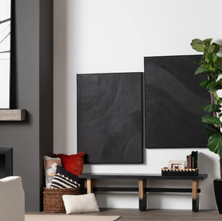 Modern living room with abstract art, a bench, and decorative items.