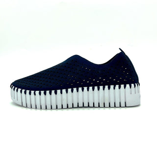 A dark indigo colored slip-on sneaker with a white sole.