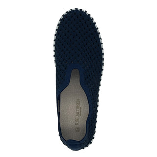 A dark indigo colored slip-on sneaker with a white sole.