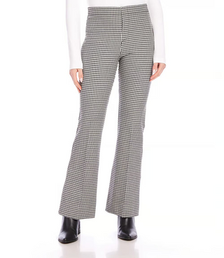 A pair of mid-rise, bootcut woven pants with a small check pattern in black and off-white, featuring a mock fly zipper and front rise.