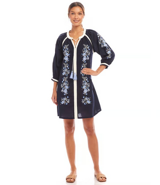 A navy peasant dress with embroidered details and a tie neck, knee-length, made from cotton blend fabric.