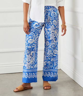 A pair of high-rise, blue floral paisley drawstring pants with wide-leg and elasticized waistband.
