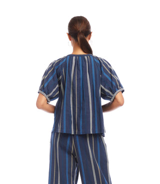 Person wearing a blue striped outfit on a white background