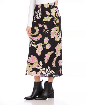 A model wearing a black, pink and green floral print midi skirt.
