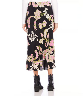 A model wearing a black, pink and green floral print midi skirt.