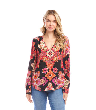 Woman wearing a colorful floral blouse on a white background. Karen Kane V-Neck Long Sleeve Shirred Blouse, Red/Magenta Print