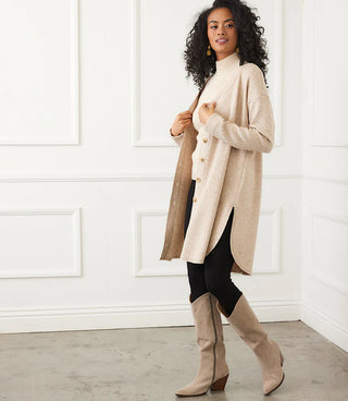 Woman wearing a beige coat, black pants, and beige knee-high boots. Karen Kane Long Sleeve Shirttail Cardigan, Oatmeal