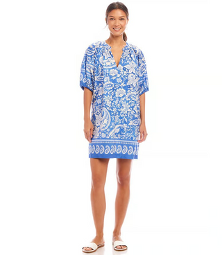 A model wearing a Karen Kane puff sleeve peasant dress with a floral paisley pattern in blue and white colors.