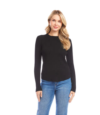 Woman wearing a black long-sleeve top and blue jeans on a white background. Karen Kane Ribbed Crewneck Sweater in Black