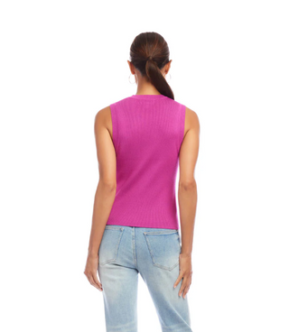 A woman wearing an orchid pink ribbed sweater tank top with a crew neck, sleeveless design, paired with light blue jeans.