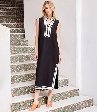 A woman models the Karen Kane St. Tropez Sleeveless Midi Dress in black with off-white contrast details.