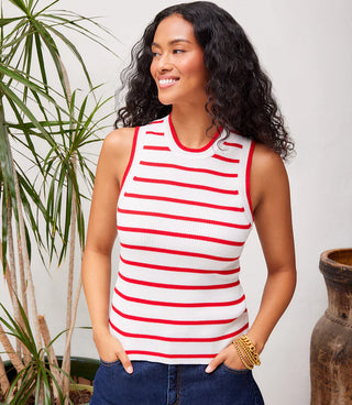 A woman wearing a red and white striped ribbed sweater tank with a crew neck, sleeveless design, and fitted at the bust, relaxed at the waist.
