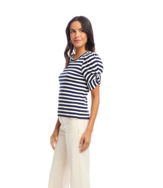 Woman wearing a navy and white striped shirt on a white background