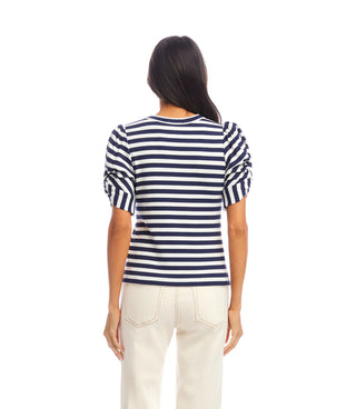 Person wearing a navy and white striped shirt on a white background