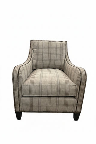 Koko Chair in Beige & Brown Plaid
A classic upholstered armchair with a beige and brown plaid fabric, dark nailhead trim, and dark wooden legs.
