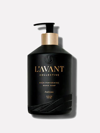 Black hand soap bottle with gold pump and 'L'Avant Collective' branding