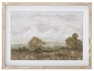 Framed landscape painting with trees and a cloudy sky