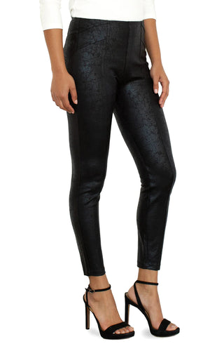 A model wearing pull on Liverpool black pants with a crackle effect and pleated detailing.
