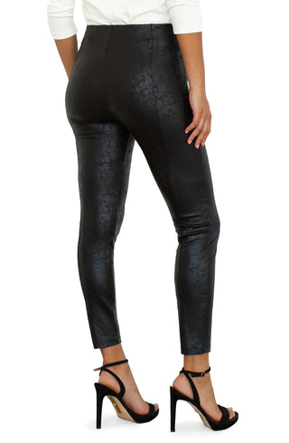 A model wearing pull on Liverpool black pants with a crackle effect and pleated detailing.