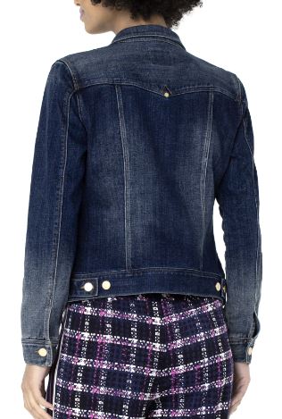 A woman wearing a blue denim jacket with ombre wash and golden hardware, featuring a front closure and two front pockets, paired with a red and black plaid skirt.