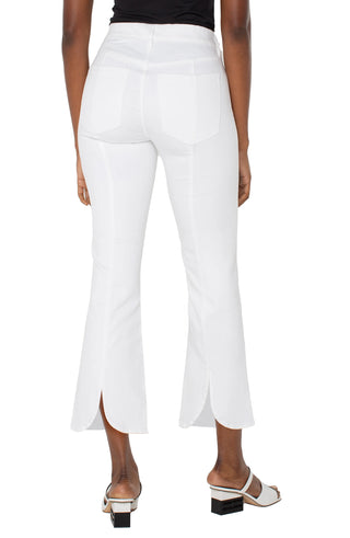 A pair of white crop flare jeans with a back pleat, mid-rise waist, and set-in waistband.