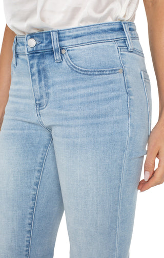 A pair of cropped flare jeans with a slit hem and mid-rise waist, in a light wash denim fabric.