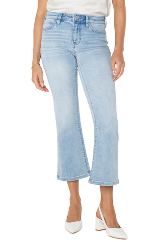 A pair of cropped flare jeans with a slit hem and mid-rise waist, in a light wash denim fabric.