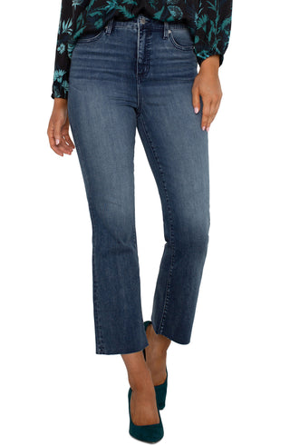 A pair of hi-rise crop flare jeans with a cut hem in a juniper valley shade, featuring a front view on a female model.