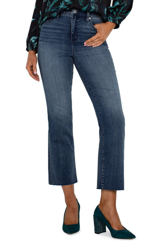 A pair of hi-rise crop flare jeans with a cut hem in a juniper valley shade, featuring a front view on a female model.