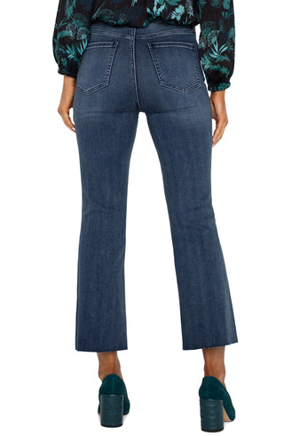 A pair of hi-rise crop flare jeans with a cut hem in a juniper valley shade, featuring a front view on a female model.