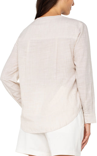 A long sleeve button front woven shirt with a banded collar in a light tan and white color combination.