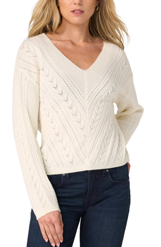 Liverpool Long Sleeve V-neck Drop Shoulder Sweater in Cream
Woman wearing a cream cable knit sweater and dark jeans on a plain background