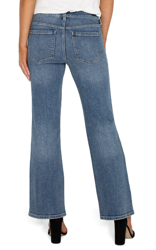 A pair of slim-fit, bootcut jeans with a high waist and button closure at the front.