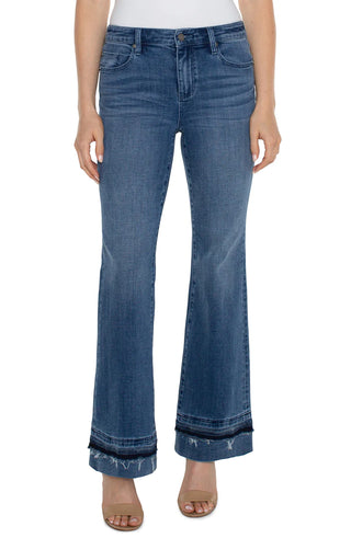 A pair of slim-fit bootcut jeans with a let-down hem.