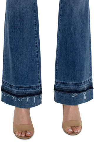 A pair of slim-fit bootcut jeans with a let-down hem.