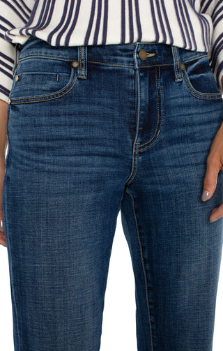 A pair of cuffed Liverpool Marley Girlfriend jeans in a medium blue wash, paired with a striped shirt and high heels.