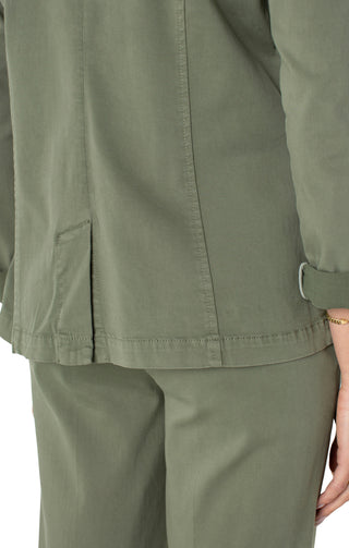 A model in a fitted olive green blazer with rolled sleeves and front pockets.