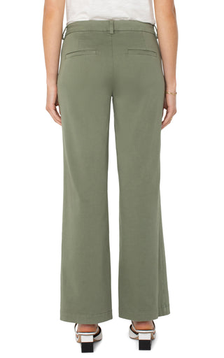 A pair of olive green wide leg Kelsey trousers with a structured waistband, paired with a white top and white sandals.
