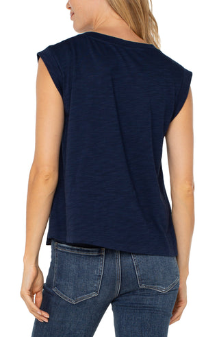A navy sleeveless woven knit top with double-layer folded sleeves, worn by a female model.