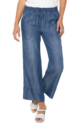 A pair of Liverpool brand wide leg pants with a tie waist and a detailed hem, in a blue denim wash.